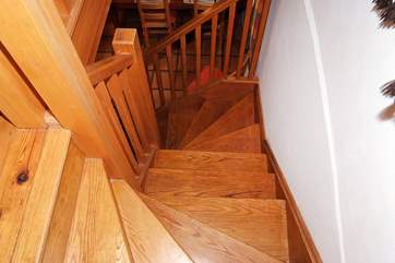 The wooden staircase leads to the master bedroom and bathroom.