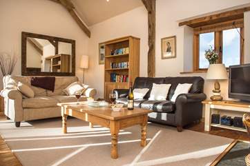 The sitting-room has wonderful high ceilings and plenty of room for all.