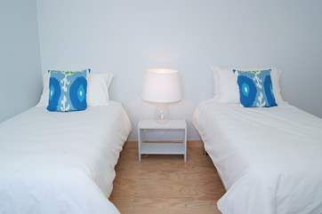 The twin bedroom is light and spacious and simply furnished.