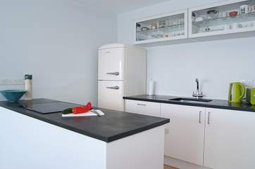 The stylish and well-equipped kitchen includes a Smeg fridge/freezer.