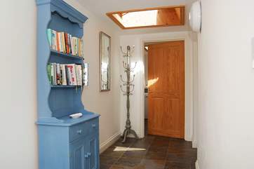 The spacious hallway leads to the utility-room.