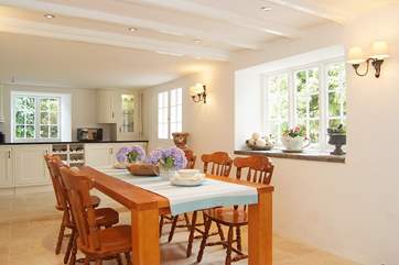 The dining-area is just a step up from the kitchen-area in this spacious room.
