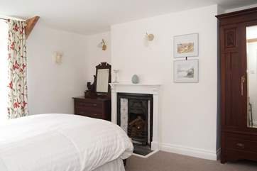 A Victorian cast iron fireplace in Bedroom 3.