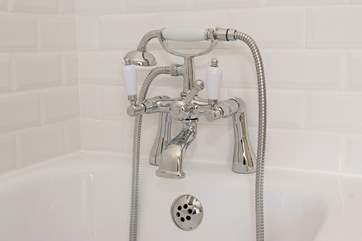 A hand-held shower attachment in the family bathroom.