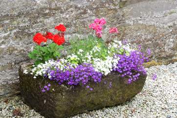 A prettily-planted old stone trough.