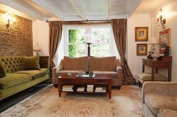 The drawing-room looks out over the little fenced courtyard to the front of the farmhouse.