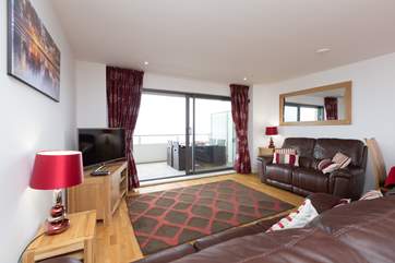 There is an open plan living/dining/kitchen area with sliding glass doors to the balcony to make the most of this excellent location.