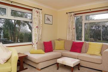 Picture windows look out onto the pretty garden.