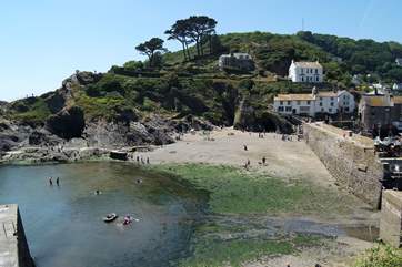 The beach at the harbour entrace appears as the tide drops back.