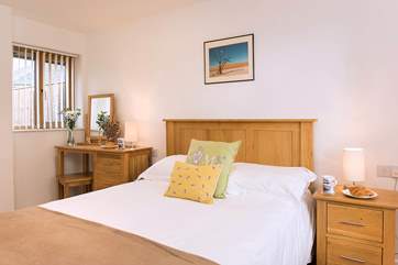 The pretty bedroom is dual aspect, making it lovely and light during the daytime.