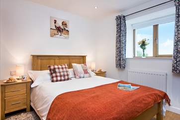 Lovely linens and soft cushions on the bed make the cottage very homely.