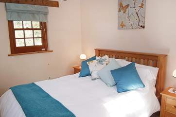 The pretty double bedroom with a 5' wooden bed.