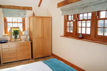 The triple-aspect double bedroom overlooks the Owners' cottage, the courtyard and to the rear the garden and countryside views.