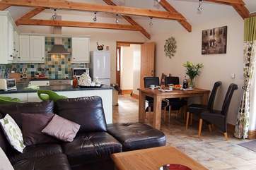 The spacious living-room with dining-area and kitchen is a very social space.