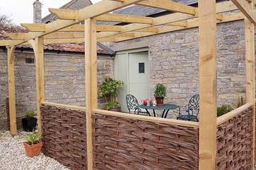 There is a lovely pergola outside the property, creating a place to sit outside.
