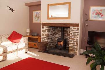 The living-room has a wood-burner and is a friendly family room to relax in.