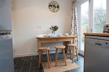 The kitchen has a small table for breakfast.