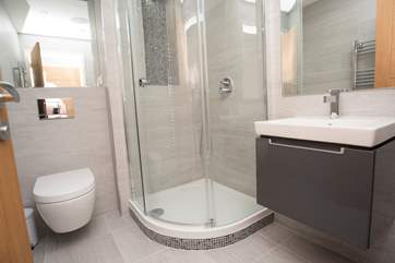 The en suite shower-room with large corner shower cubicle and wall hung Villeroy and Boch hand-basin and WC.