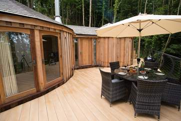 The deck sits out over the woodland.