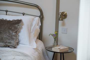 The bed enjoys the views out the double doors to the deck and beyond.