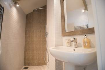 Next to the king-size bed is the walk in wet-room.