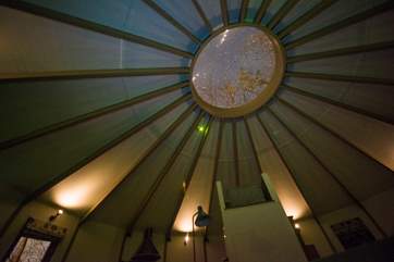 While away the hours star-gazing out of the traditional yurt ceiling window.