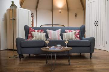 The sofa looks straight out the double doors across the deck to the view in the distance.