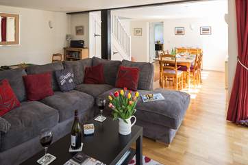 This sociable room has plenty of space for the L-shaped sofa, two armchairs, a play-area and the dining-area.
