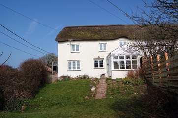 Kentisbury Cottage has an enclosed garden with a wooden fence on one side and a bank and hedging to the other. The garden seating and barbecue are at the bottom end of the garden.