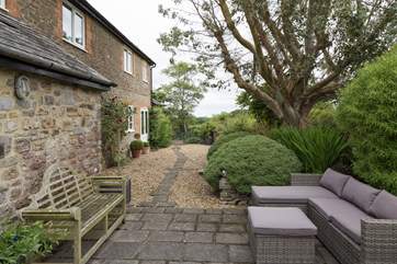 This elegant farmhouse has magnificent gardens that surround and complement.