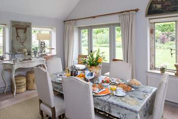 The stylish dining room encourages lazy breakfasts and long delicious suppers; walk through the large door to the beautiful walled garden.