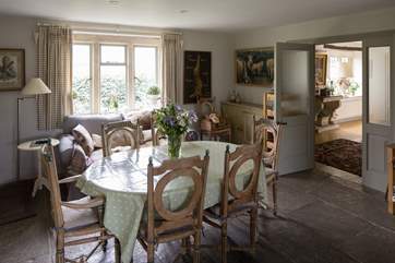 A second dining table with the entrance hall beyond.