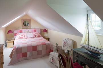 The second floor bedroom suite (bedroom 4) is tucked away at the top of the house, with a double bed.