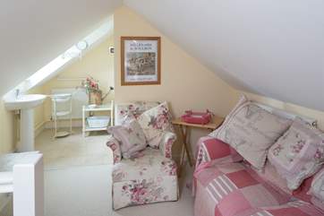 This pretty sitting area links the top floor bedroom suite with it's own bathroom at the far end.