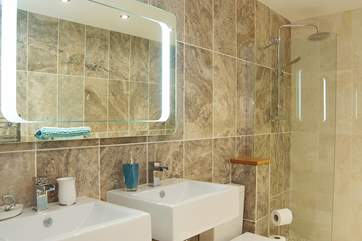 Twin basins and an LED-lit mirror in the shower-room.
