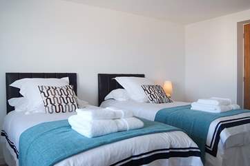 Bedroom 2 has 'zip-and-link' (3' twins or 6' double) beds, shown here made up as twin.