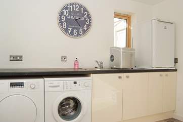 The useful utility-room has a washing machine, tumble-drier, second fridge and an ice maker.