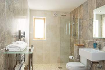 The bathroom has a walk-in shower and a freestanding bath.