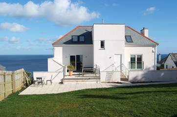 The back garden has plenty of lawn space and sunny patio areas.