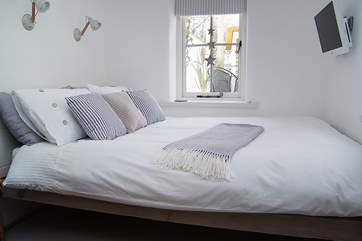 The bed with a TV at the end.