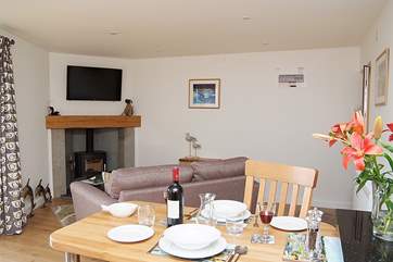 The open plan living-room in Rame includes a warming wood-burner.