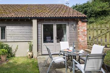 The sheltered garden at the rear of the cottage can be accessed via a little gate or from the master bedroom via French doors.