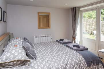 The master bedroom has a 5' bed, plenty of storage in fitted wardrobes and French doors that lead out to the enclosed and secluded rear garden.