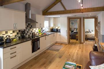 There is a sleek contemporary kitchen with plenty of storage space.