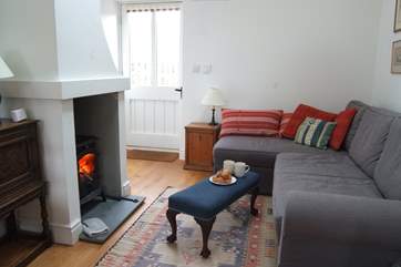 The front door opens into the open plan living-room with comfy L-shaped sofa.