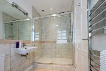 The shower room boasts a huge shower and modern fittings.