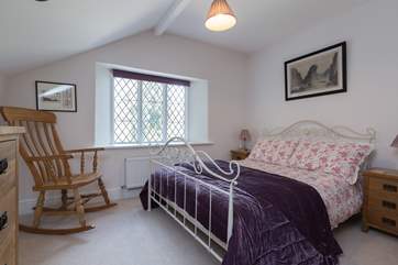 There is also a double bedroom with a view out over the terrace and the wooded hillside.