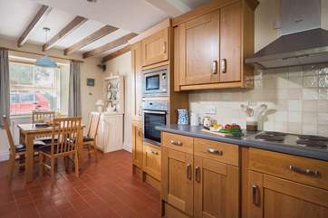 The open plan kitchen/dining-room has plenty of space to prepare, cook and eat a meal.