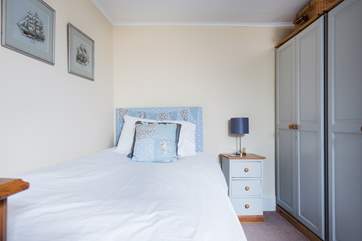 This pretty single bedroom has plenty of storage.