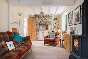 The comfy sofa and chairs are perfect for relaxing after a day out exploring with or without the wood-burner.